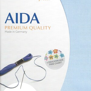 May include: A light blue Zweigart Aida fabric precut measuring 19 inches by 21 inches or 48 cm by 53 cm. The packaging features the text AIDA PREMIUM QUALITY, Made in Germany, 16 ct., and includes a purple embroidery thread skein and a needle.