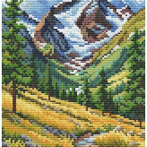 May include: A cross-stitch landscape depicting a mountain scene. The image features a snow-capped mountain, green trees, a stream, and a field of yellow and green grass. The sky is blue with white clouds. The artwork is created with small, square stitches.