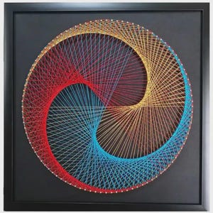 May include: A framed string art piece featuring a circular design created with red, gold, and blue threads wrapped around pins. The threads form a swirling, three-part geometric pattern against a solid black background within a black frame.