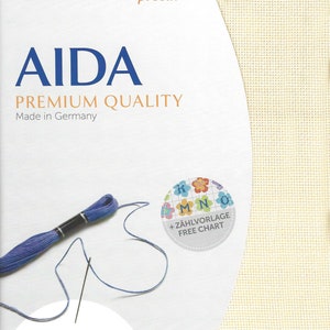 May include: Zweigart precut Aida fabric in cream, featuring a premium quality label, Made in Germany text, and a free chart sticker. Includes a length of blue embroidery floss with a needle, and dimensions of 48 x 53 cm or 19 x 21 inches.