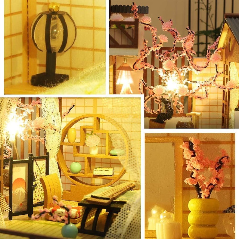 May include: A miniature dollhouse with a wooden frame and a white lace curtain. The dollhouse features a small, wooden table with a lamp and a shelf with a variety of miniature items. The dollhouse is decorated with pink flowers and a small, wooden tree.