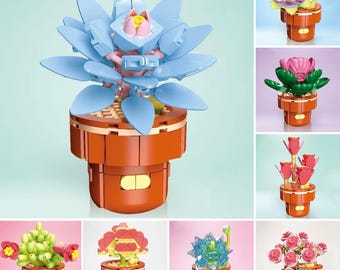 May include: A collection of colorful, miniature flower pot models. The models feature various flower designs, including a blue lotus, pink roses, and green succulents, all set in orange pots. These decorative pieces are ideal for home decor.