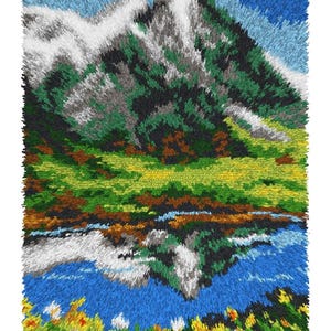 May include: A textured art piece depicting a mountain landscape with a lake and flowers. The mountain features green, gray, and white textures, with a blue sky and clouds. The lake reflects the mountain, and flowers are at the bottom.