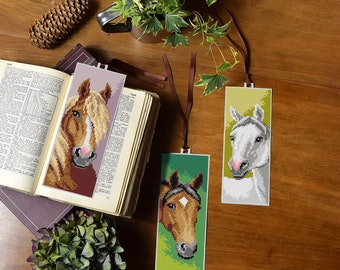 May include: Three horse head bookmarks with colourful backgrounds. The bookmarks are made of fabric and have a ribbon attached for hanging.