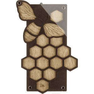 May include: A wooden wall hanging with a cutout of a bee and honeycomb. The bee is brown and yellow with black stripes. The honeycomb is made of hexagonal shapes and is brown.