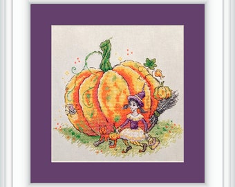 May include: A cross-stitch pattern featuring a witch with a broom and a large orange pumpkin. Two small orange cats are sitting near the pumpkin. The background is a white fabric with a purple border.