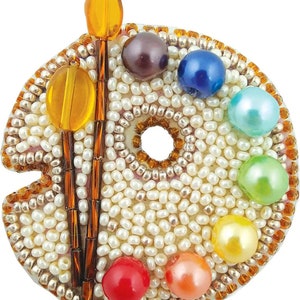 May include: A white beaded artist's palette with a brown paintbrush and colorful pearl beads in the shape of a rainbow.