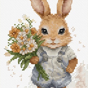 May include: A brown bunny rabbit wearing a blue shirt holds a bouquet of white and yellow flowers. The bunny is standing on a white background.