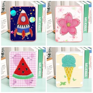 May include: Four colourful string art kits with different designs: a rocket ship, a flower, a watermelon slice, and an ice cream cone. Each kit comes with a wooden frame, nails, and colourful string.