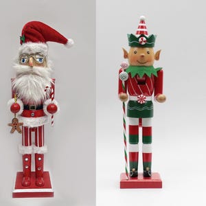May include: Two wooden Christmas nutcrackers: Santa Claus and an elf. The Santa nutcracker wears a red hat, glasses, and a white beard. The elf nutcracker has a green hat and a red and green outfit. Both stand on red bases.