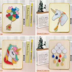May include: Four wooden frames with gold trim, each containing a colorful string art design. The designs include a unicorn, a cloud with raindrops, a unicorn with a rainbow mane, and a bunch of colorful hearts.