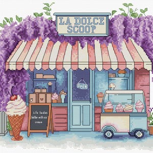 May include: Cross-stitch design of an ice cream shop called "La Dolce Scoop". The shop has a striped awning, a sign, and a cart displaying ice cream cones. A sign reads "Life tastes better with ice cream."