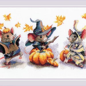 May include: Three mice dressed in Halloween costumes. One mouse is wearing a witch's hat and holding a stick. Another mouse is wearing a bat costume and a third mouse is wearing a mummy costume. All three mice are standing in front of pumpkins.