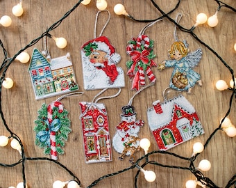 May include: Eight handmade Christmas ornaments featuring a variety of winter themes, including a snowman, a house, a candy cane, and Santa Claus. The ornaments are made with colorful embroidery floss and are perfect for adding a touch of handmade charm to your holiday decor.