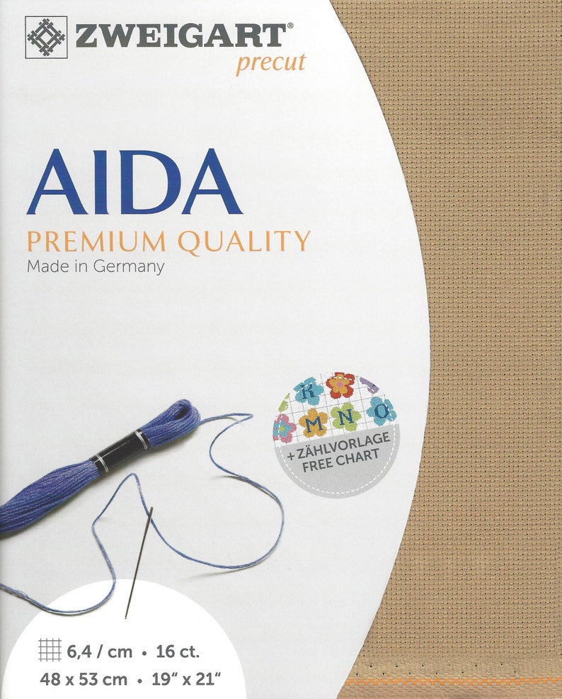May include: A Zweigart precut Aida fabric in a tan color, measuring 48 x 53 cm or 19 x 21 inches. The packaging features blue text, a skein of blue embroidery thread, and a circular graphic with colorful flowers and the text + Z&Auml;HLVORLAGE FREE CHART.