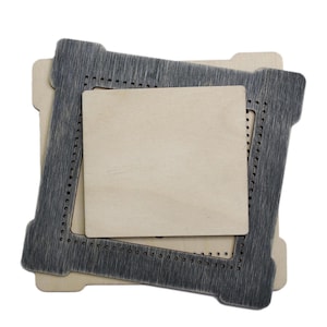 May include: Two wooden frames, one nested inside the other. The outer frame is dark grey and the inner frame is light brown. Both frames have a decorative pattern of small holes around the edges.