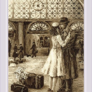 May include: A black and white photo of a couple embracing in a train station. The woman is wearing a white dress and the man is wearing a suit and hat. There are suitcases and flowers in the foreground.