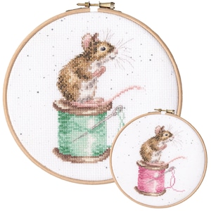 May include: Two cross-stitch embroidery hoops with a brown mouse sitting on a spool of thread. The larger hoop has a green spool of thread and the smaller hoop has a pink spool of thread.