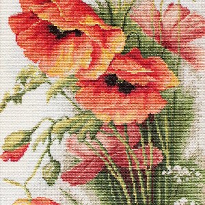May include: Cross-stitch of a bouquet of red poppies with black centers, yellow accents, and green foliage. The flowers are in full bloom, with some buds visible. The background is white.