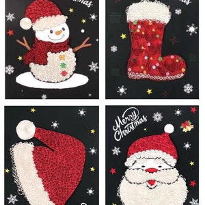 May include: Four Christmas-themed paper crafts on a black background. The crafts are made of paper rolls and feature a snowman, a stocking, a Santa hat, and Santa's face. Each craft has the words "Merry Christmas" written on it.