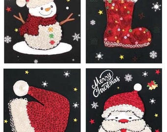 May include: Four Christmas-themed paper crafts on a black background. The crafts are made of paper rolls and feature a snowman, a stocking, a Santa hat, and Santa's face. Each craft has the words "Merry Christmas" written on it.