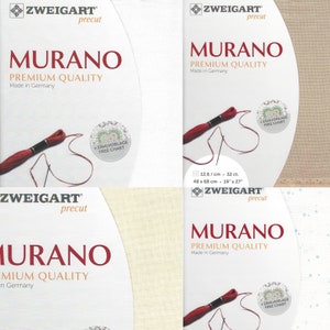 May include: Four packages of Zweigart Murano Aida fabric, a type of cross stitch fabric, in precut sizes. Each package features a red and white embroidery floss, a free chart, and the text "Zweigart Murano Premium Quality Made in Germany".
