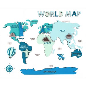 May include: A colorful wooden world map with the words "WORLD MAP" at the top. The map features various continents in shades of blue and green, with miniature landmarks and ocean names.