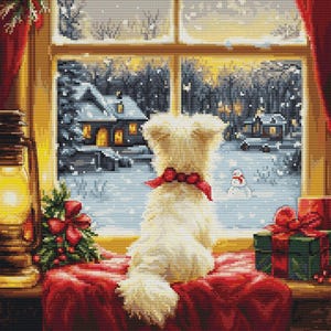 May include: A white dog sits by a window looking out at a snowy winter scene. The dog is wearing a red ribbon around its neck. There is a lit lantern on the left side of the image and wrapped presents on the right side of the image.