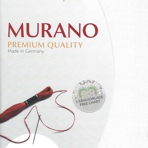 May include: White Aida fabric with a red embroidery floss and needle. The fabric is precut and measures 19 inches by 27 inches. The packaging includes a free chart for the Murano cross stitch pattern.