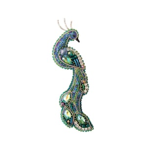 May include: A peacock brooch made of green and blue beads and rhinestones. The peacock is standing upright with its tail feathers spread out.