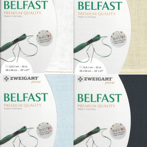 May include: A pack of white, beige, light blue, and dark blue Aida fabric for cross-stitch. The fabric is precut and labeled "Zweigart Belfast Premium Quality Made in Germany". The fabric is 19 inches by 27 inches and has a count of 32 stitches per 10 centimeters.