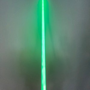 以下が含まれることがあります： 黒い柄の緑色のライトセーバーのおもちゃ