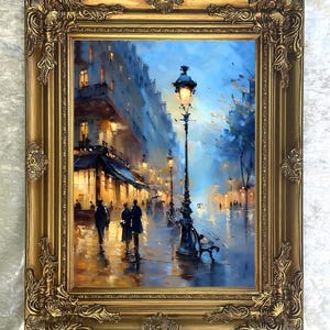 May include: An oil painting of a European street scene at night, framed in a gold ornate frame. The artwork depicts a wet street with figures walking, illuminated by streetlights and building lights. The color palette includes blues, golds, and browns.