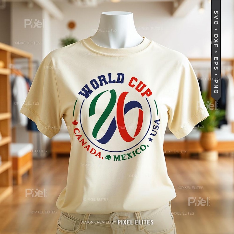 May include: Cream-colored t-shirt featuring a circular graphic for the World Cup 26, with the number 26 in green, blue, and red. The text includes "CANADA, MEXICO, USA". The shirt is displayed on a mannequin.
