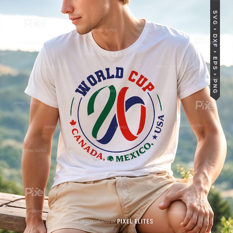 May include: White t-shirt featuring a circular graphic for the 2026 World Cup, with the text "WORLD CUP" at the top and "CANADA, MEXICO, USA" around the bottom. The number "26" is in the center, with green, blue, and red accents.