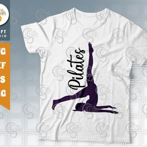 May include: White t-shirt with a black silhouette of a person doing a pilates pose and the word "Pilates" in black text.