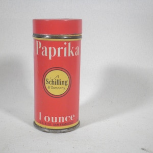 May include: A red metal tin with a yellow label that reads "Paprika" and "A Schilling & Company". The tin also says "1 ounce" and "A. Schilling & Co. San Francisco".