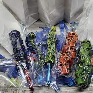 May include: A white ceramic mug with a black handle and the text "But First, Coffee" in a black, bold font. The mug is sitting on a wooden surface. The mug is 4 inches tall.