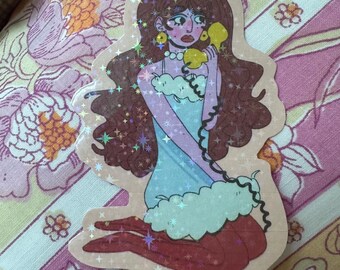 May include: A sticker featuring a seated woman with long brown hair, holding a yellow telephone. She wears a light blue dress with a white cloud-like trim and red tights. The sticker has a holographic, glittery effect.