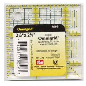 May include: A yellow and white 2 1/2 inch by 2 1/2 inch Omnigrid ruler with a grid pattern and a barcode. The ruler is labeled "Omnigrid" and "R25G".