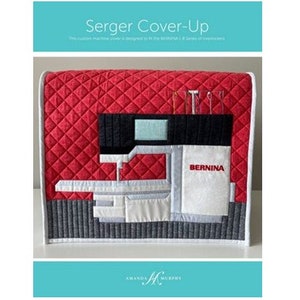 May include: A red, white, and gray quilted sewing machine cover with the word "BERNINA" printed on the front. The cover is designed to fit the BERNINA 1, 2, and 3 series of overlock machines.