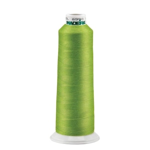 May include: A spool of bright green thread with the text "MADEIRA" and "8990" on the label.