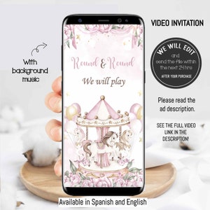 May include: A pink and gold carousel with white horses and balloons. The text "Round & Round We will play" is on the screen. The text "VIDEO INVITATION" is on the right side of the screen. The text "WE WILL EDIT and send the file within the next 24 hrs AFTER YOUR PURCHASE" is in a circle on the right side of the screen. The text "Please read the ad description." is below the circle. The text "SEE THE FULL VIDEO LINK IN THE DESCRIPTION!" is below the ad description. The text "Available in Spanish and English" is at the bottom of the screen.