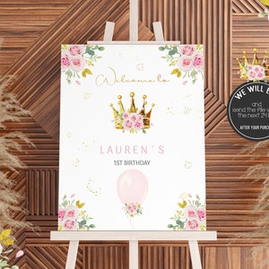 May include: A white printable sign with a gold crown and pink flowers. The sign says "Welcome to Lauren's 1st Birthday".