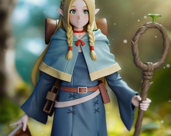 May include: A 3D printed figurine of a female elf wearing a blue and white robe with a red ribbon around her neck. She has long blonde hair in braids and is holding a book and a staff. The background is a blurred forest scene.