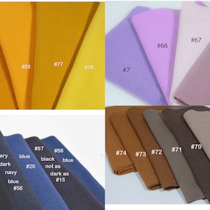 May include: A collection of fabric swatches in various colors, including mustard yellow, light purple, pink, brown, and dark blue. The swatches are labeled with numbers, such as #7, #53, #67, #74, and #56.