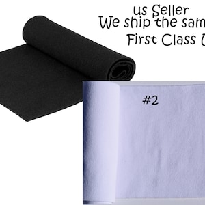 May include: Two rolls of elastic knit fabric, one black and one white. The fabric is ribbed and has a slight sheen. The rolls are labeled #1 and #2.