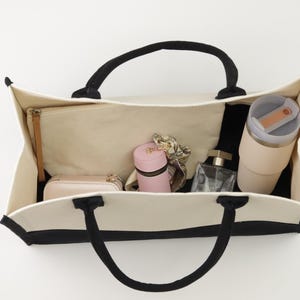 a purse hanging on a wall with a lot of items inside