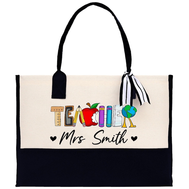 a black and white bag with a teacher's apple on it