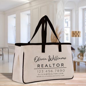 a white bag with a black ribbon hanging from it